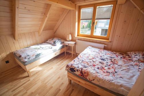 a bedroom with a bed and a window in a cabin at Antosiowy domek in Wisła