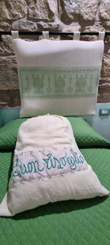 a bed with a pillow and a pillow with the words bowhedon at B&B Martina in Senorbì