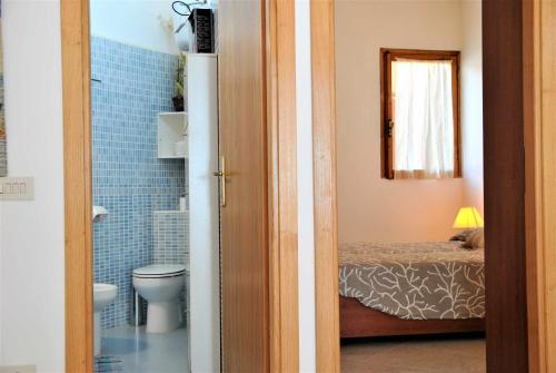 een kamer met een badkamer met een toilet en een bed bij La Sirenetta tra mare e collina in Sperlonga