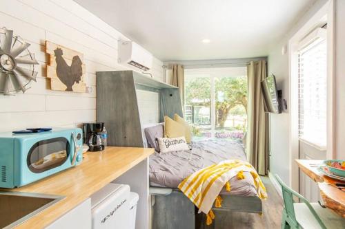 a small kitchen with a bed in a tiny house at The Container Retreat @290 Wine Trail #3 Hill Country bliss in Hye