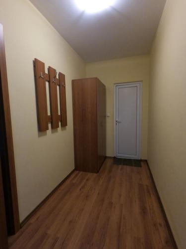 an empty room with wooden floors and a door at Rusaliite Adventure House in Bachevo