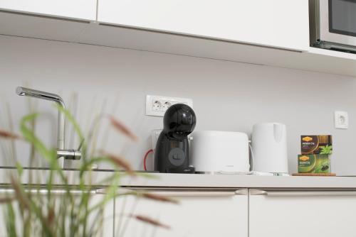 a kitchen counter with a phone on a counter top at Cozy apartments in Ljubljana