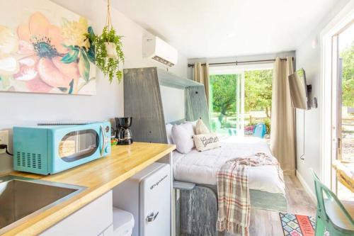 a small kitchen with a sink and a bed in a room at The Container Retreat @ 290 Wine Trail #5 Starry nights in Hye