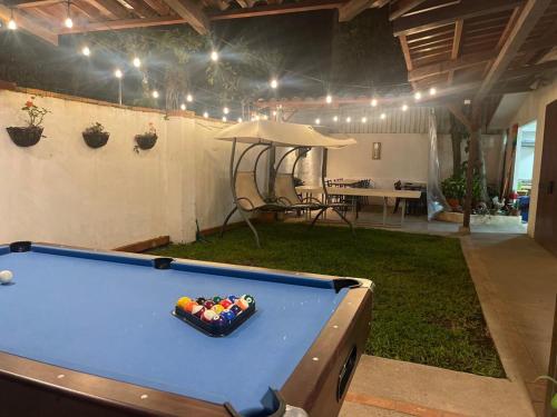 a pool table with a bowl of balls on it at Casa Escalante Hostel in San José