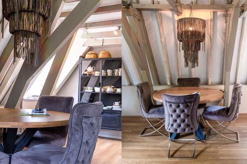 a dining room with a wooden table and chairs at Sterlogies City Penthouse in Leeuwarden