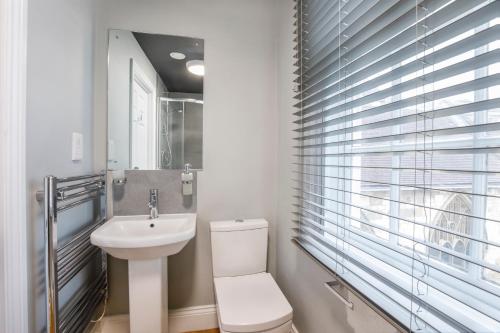 a bathroom with a white toilet and a sink at Turpin Quarter in the centre of the city, sleeps 6 in York