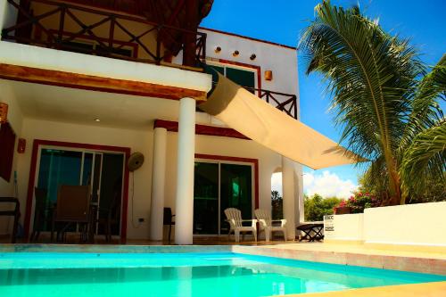 a villa with a swimming pool in front of a house at Rodas villas contiguas para la vacación perfecta in San Bruno