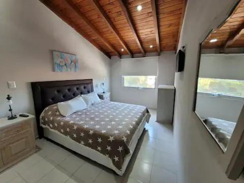 a bedroom with a bed and a television in it at CORDOBA AEROPUERTO KEMPES y HOSPITAL ALLENDE ETC in Cordoba