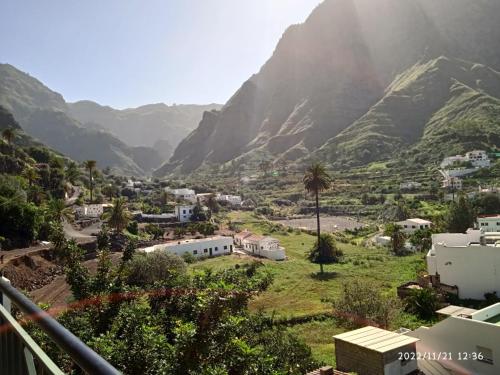 a village in a valley with mountains in the background at Lagarto in Agaete