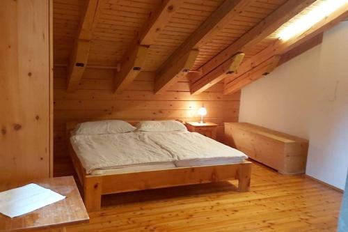 a bedroom with a bed in a wooden room at Chalet Sennhütte Obertauern mit Zirbensauna und neuem XL Bad in Obertauern