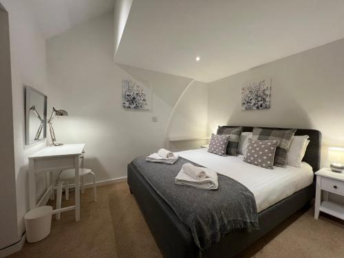 a bedroom with a bed and a desk in it at Jackfield Old School in Coalport