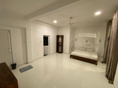Ein Bett oder Betten in einem Zimmer der Unterkunft Manjari Villas Madiha