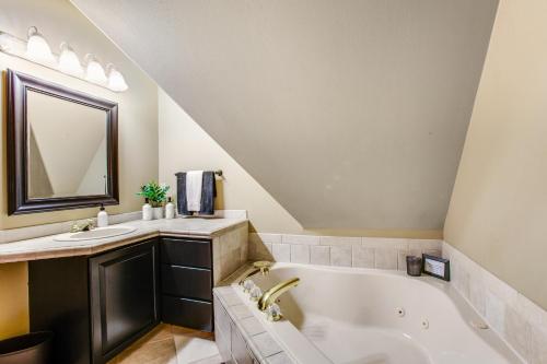 a bathroom with a tub and a sink and a mirror at Snoqualmie Summit Chalet in Snoqualmie Pass