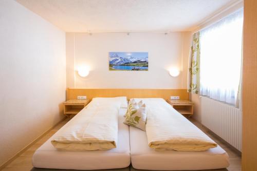 a hospital room with two beds and a window at Pension Anna in Sankt Leonhard im Pitztal