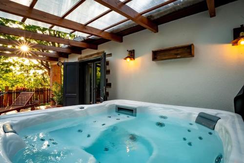 a jacuzzi tub in the middle of a patio at Cityside Cottage in Eger