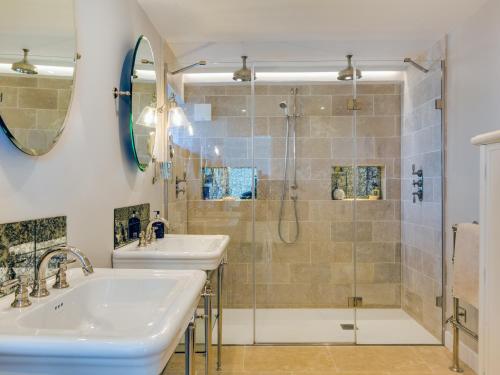 a bathroom with two sinks and a shower at The Farmhouse - within the Helland Barton Farm collection in Delabole