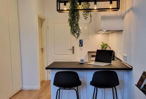 a kitchen with a island with a laptop computer on it at Modernes Apartment Karlsruhe in Karlsruhe