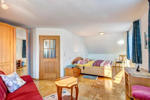 a bedroom with a bed and a living room at Wieckblick Krummin 17b in Krummin