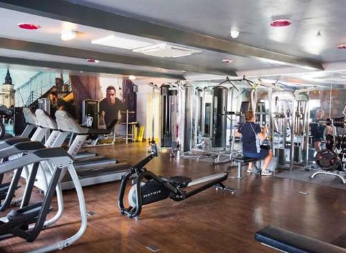 a gym with several people exercising in the gym at Jubilee Beach House in Filey