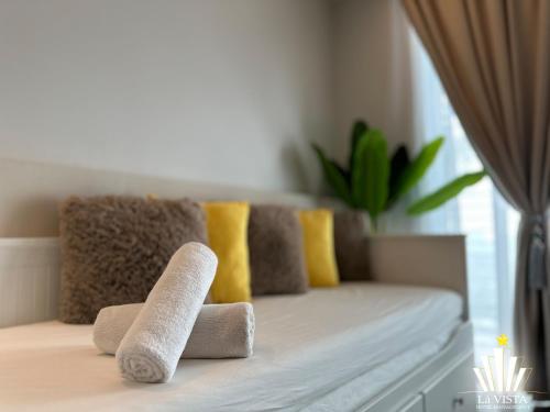 a couch with two rolled up towels on it at The Shore Hotel & Residences By Lá VISTA in Melaka