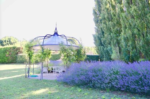 a gazebo in a garden with purple flowers at LASUITE Domaine Bertuli, heated Pool, Aircon in Oppède
