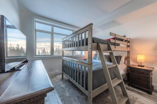 戈爾登的住宿－Fully Renovated Ski-in/out Loft with Private Hot Tub!，一间卧室设有双层床和楼梯。