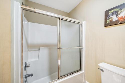 a shower with a glass door in a bathroom at Mt Yonah Studio B in Helen