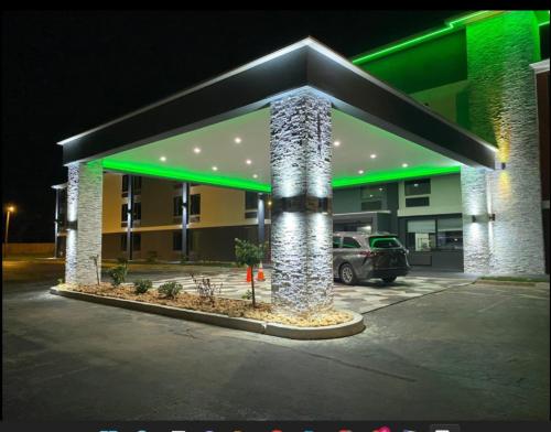 a gas station at night with green lights at Baymont by Wyndham Chattanooga Eastridge in East Ridge