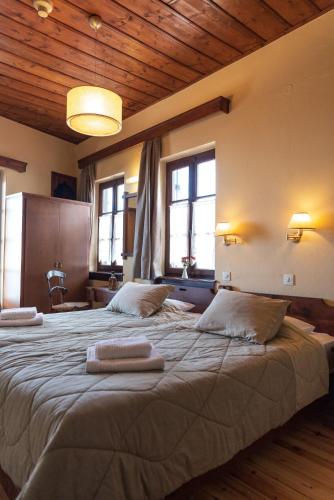 a bedroom with two large beds with towels on them at Kentavros Hotel in Agios Lavrentios