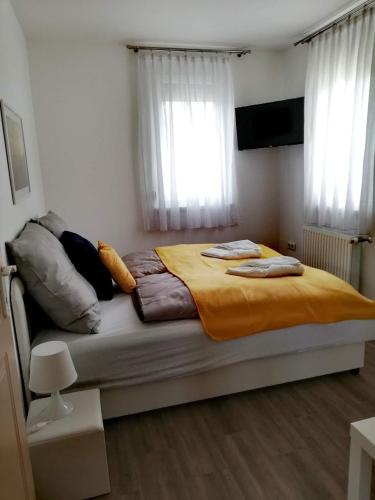 a bedroom with a large bed with two pillows on it at Happy Apartments in Balatonlelle