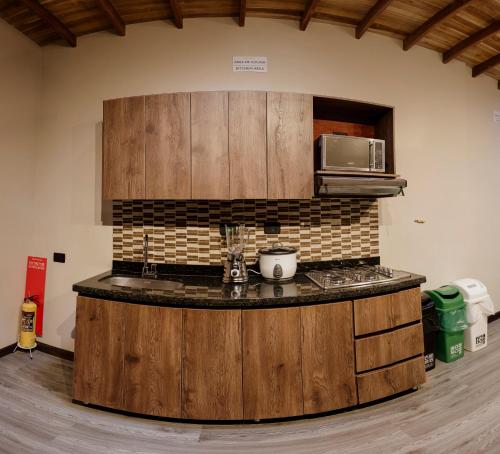 una cocina con una isla de madera en una habitación en Hostal Machu Picchu Medellín, en Medellín
