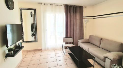 a living room with a couch and a television at GO to apartments in Leonardo in Bat Yam