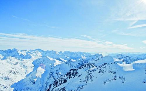 a view of a mountain range with snow at Hotel Post in Bad Gastein