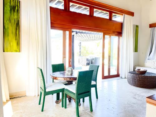 a dining room with a table and chairs at Ileverde 21 - Private garden Bungalow in Punta Cana