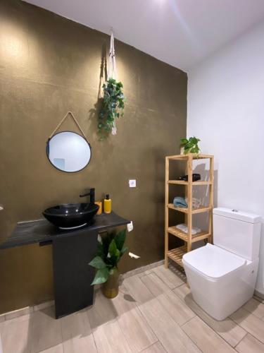 a bathroom with a sink and a toilet at Hostal Orange Vibes in Paterna