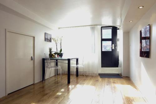 a hallway with a black table and a door at Amsterdam Boutique Apartments in Amsterdam