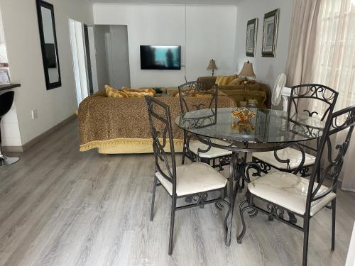 a living room with a table and chairs and a bed at Marielitsa Inn in Germiston