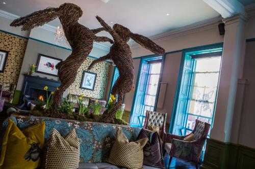 a living room with a large sculpture of two people at Oddfellows Chester Hotel & Apartments in Chester