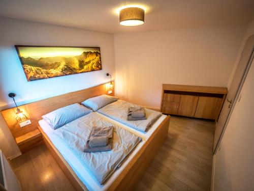 a bedroom with a bed with two pillows on it at Apartmany Vila Vista in Demanovska Dolina