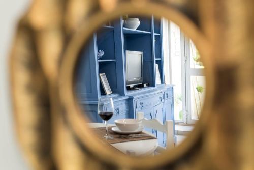 a room with a table with a glass of wine at GOLD - Vilamoura in Vilamoura