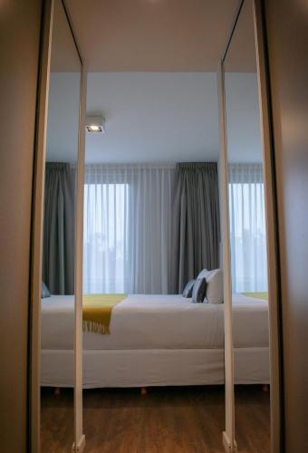 a reflection of a bed in a mirror at KOS Pilar Hotel in Pilar