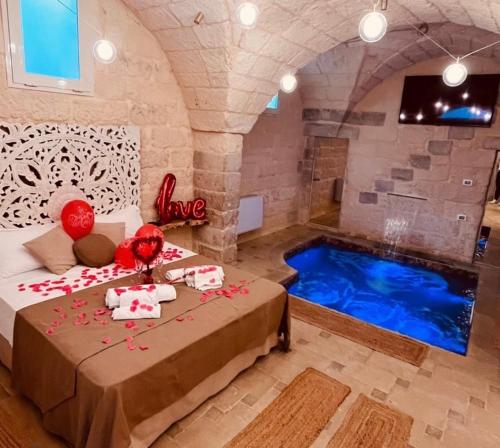 a room with a bed and a swimming pool at CORTE COCHLEA in Cannole