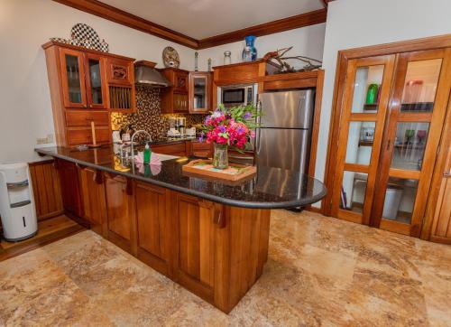 a kitchen with a black counter top and wooden cabinets at Captain Morgan's Retreat in San Pedro