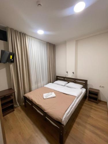 een slaapkamer met een bed met twee handdoeken erop bij ART family hotel in Tbilisi City