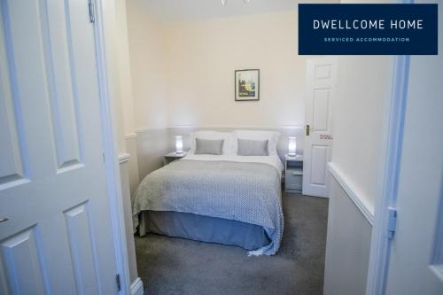 a white bedroom with a bed with two pillows at Entire 8 Ensuite Bedroom Coastal Holiday Home Townhouse, Free Parking, Fully Equipped Kitchen, Dining Room & Lounge, Perfect for Family Gatherings, Long Term Contractor, Relocation, etc Stays, 20 mins to Sunderland & Newcastle, See our Site for Assurance in South Shields