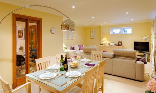 a dining room and living room with a table and chairs at Merewood Lodge in Ambleside