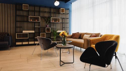 a living room with a couch and chairs and a table at Park Hotel in Tiraspol