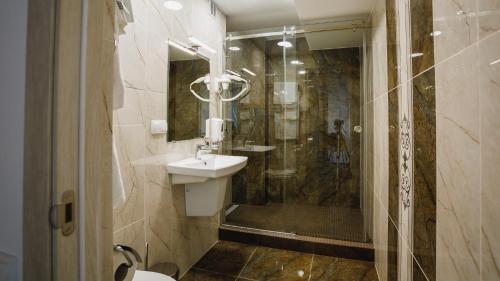 a bathroom with a sink and a shower at Park Hotel in Tiraspol
