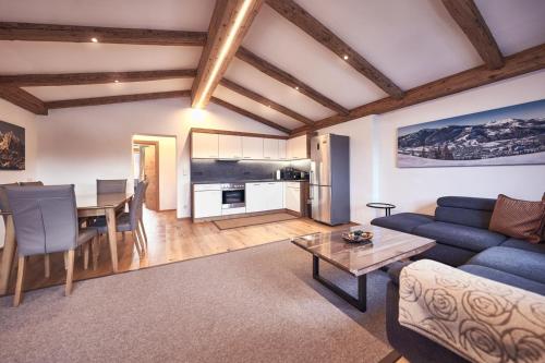 a living room with a blue couch and a table at Haus Josef-Herold-Straße 17a in Kitzbühel