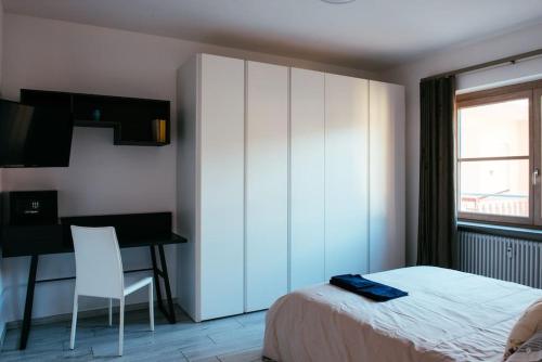 a bedroom with a bed and a desk and a chair at Casa Medici in Asti